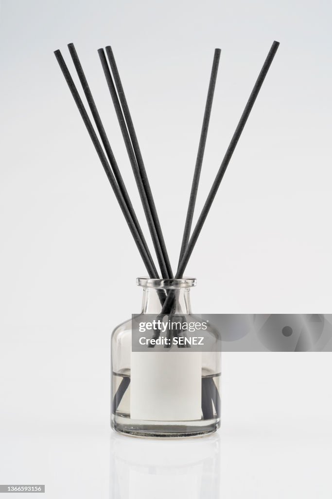 Home fragrance diffuser with wooden sticks isolated on white background