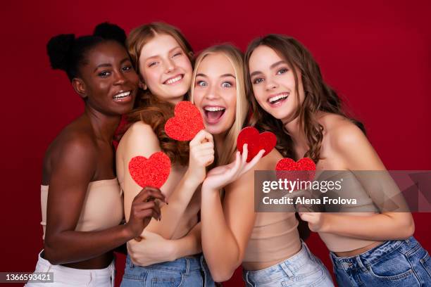 portrait of beautiful young women with make-up holding shapes of heart - バレンタイン　友人 ストックフォトと画像