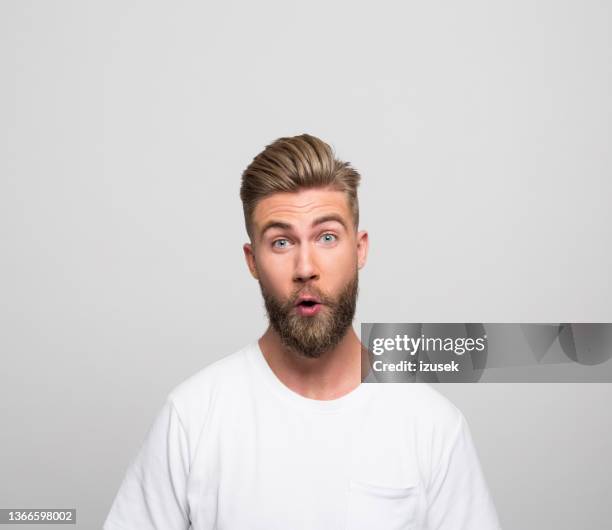 headshot of surprised young man - vissla bildbanksfoton och bilder