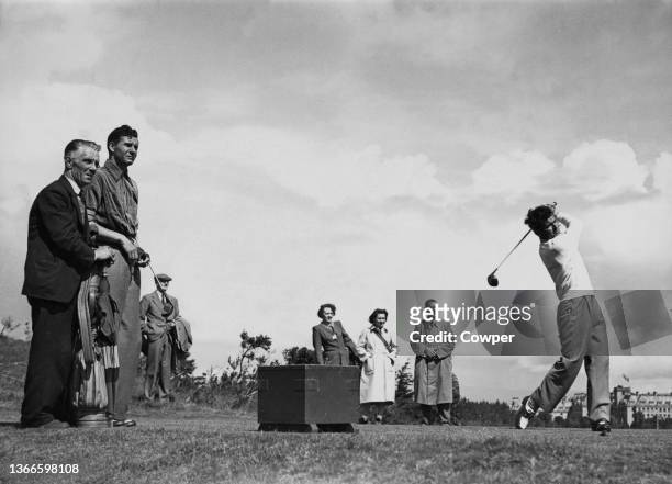 Dai Rees from Wales follows his drive off the tee watched by his opponent Flory Van Donck of Belgium and a group of spectators during the 1948...