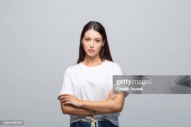 portrait of displeased young woman - arms crossed angry stock pictures, royalty-free photos & images