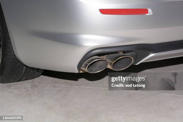 exhaust pipe of a silver car - stock photo car chrome bumper stock pictures, royalty-free photos & images