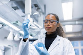 Woman scientist experimenting with chemicals in lab