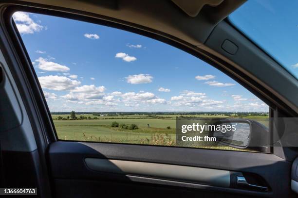 landscape view through the window of a car with rearview mirror - window frame stock pictures, royalty-free photos & images