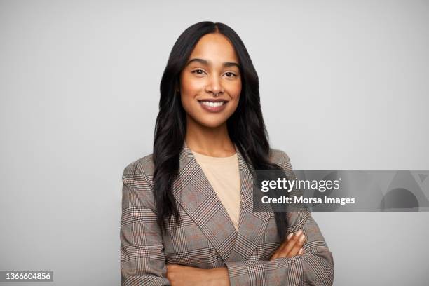 happy african american businesswoman against white background - black blazer foto e immagini stock