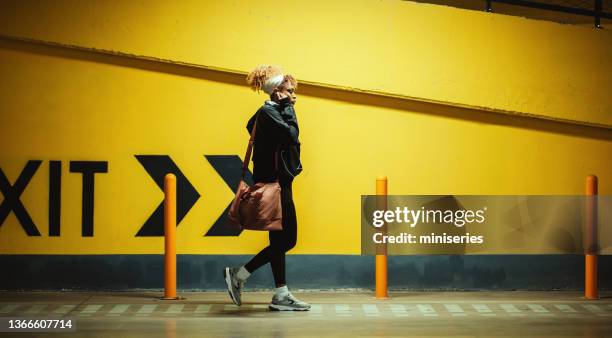 afro-american woman going to the gym - evening walk stock pictures, royalty-free photos & images