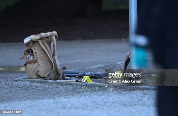 Long gun and a knife believed to belong to the attacker lie outside a building of Heidelberg University following a shooting that left the attacker...