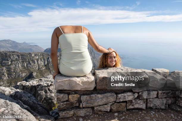 a fun picture of girl holding her head next to her - fake smile stock-fotos und bilder