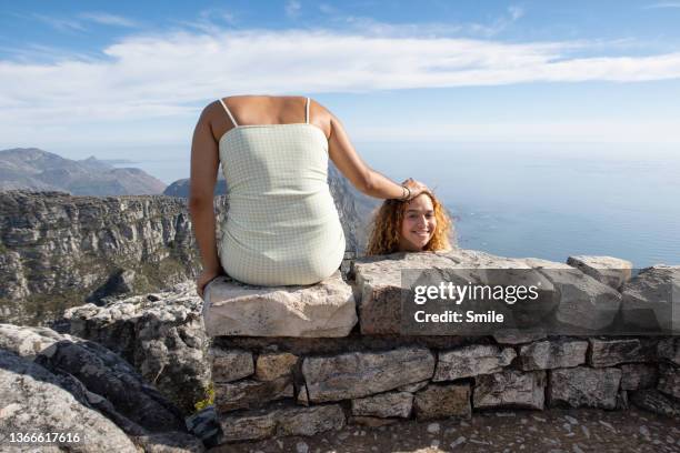 a fun picture of girl holding her head next to her - offbeat stock-fotos und bilder