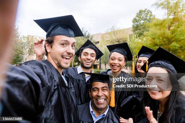 diverse friend group poses for selfie after graduation - black woman graduation stock pictures, royalty-free photos & images