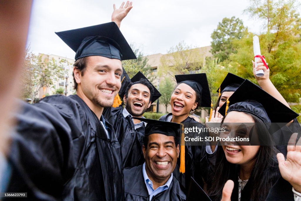 Diverse friends group takes joyful photo after graduation