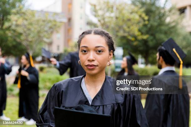 portrait serious, upset female graduate - black woman graduation stock pictures, royalty-free photos & images