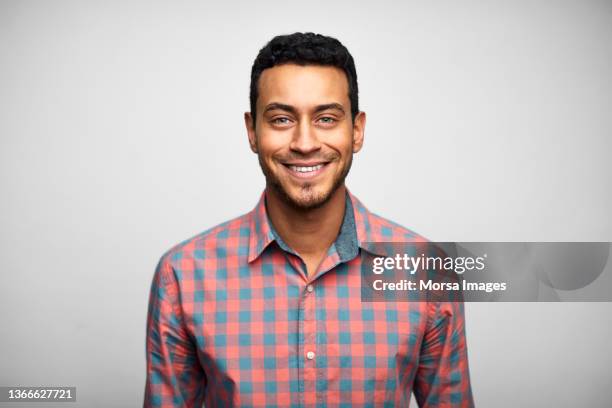 handsome young adult businessman with stubble - checked shirt - fotografias e filmes do acervo