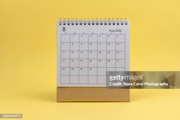 august 2022 desk calendar on yellow background - calendar page stock pictures, royalty-free photos & images