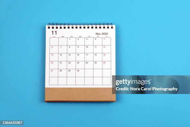 november 2022 desk calendar on blue background - novembre foto e immagini stock