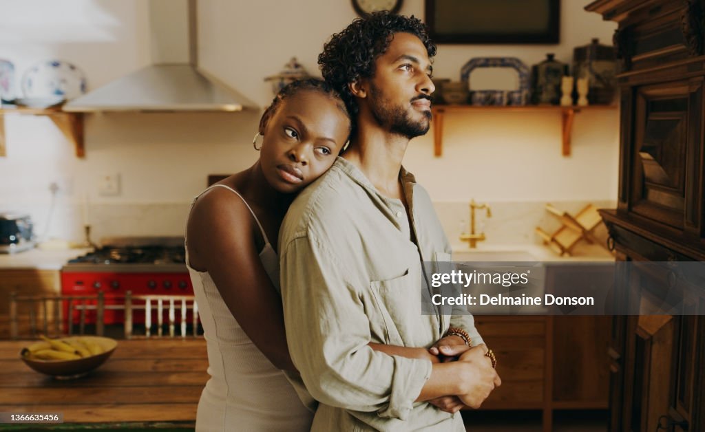Shot of an attractive young woman hugging her boyfriend while bonding with him at home