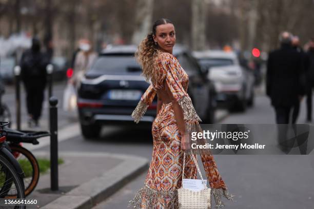 Carla Ginola wearing an colorful dress with patern and brown boots outside Paco Rabanne on January 23, 2022 in Paris, France.