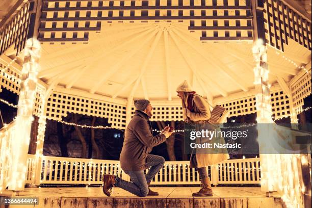 romantic proposing in romantic mood - engagement stock pictures, royalty-free photos & images