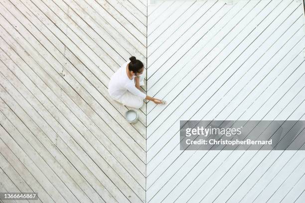 high angle view of asian woman painting deck - timber yard stock pictures, royalty-free photos & images