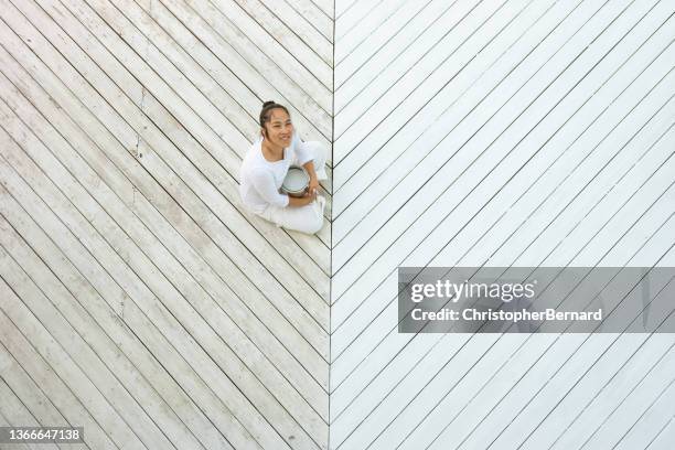 above view smiling asian woman painting deck - backyard deck stockfoto's en -beelden