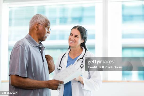 senior patient learns about home care options - blank brochure stockfoto's en -beelden