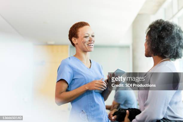 caring female physical therapist talking with patient - group women support doctor stock pictures, royalty-free photos & images