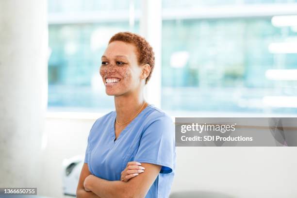 mid adult female surgeon stands in office in hospital building - nurse candid stock pictures, royalty-free photos & images