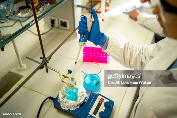 woman researcher working in the laboratory - laboratory shaker stock pictures, royalty-free photos & images