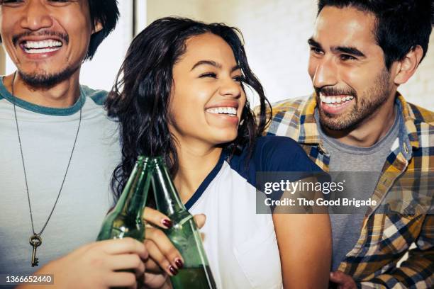 cheerful friends drinking beer at party - man sipping beer smiling stockfoto's en -beelden