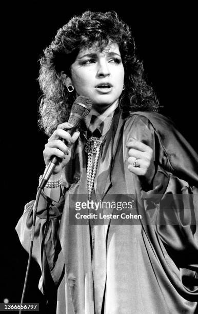 Cuban and American singer, actress, and businesswoman Gloria Estefan, of Gloria Estefan and the Miami Sound Machine, sings on stage circa 1988 in Los...