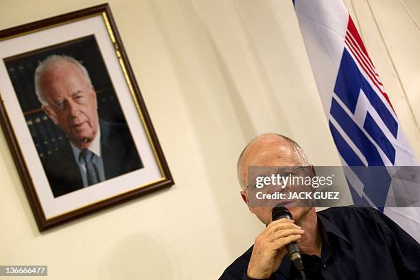 Noam Shalit, whose soldier son Gilad was held captive in Gaza for over five years, speaks during a press conference under a portrait of late Israeli...