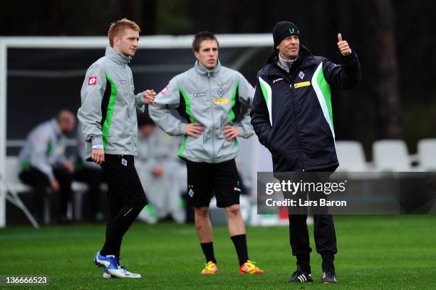 Head coach Lucien Favre gestures next to Marco Reus and Patrick Herrmann during a training session at day six of Borussia Moenchengladbach training...