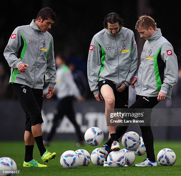 Marco Reus is seen with Roman Neustaedter and Roel Brouwers during a training session at day six of Borussia Moenchengladbach training camp on...