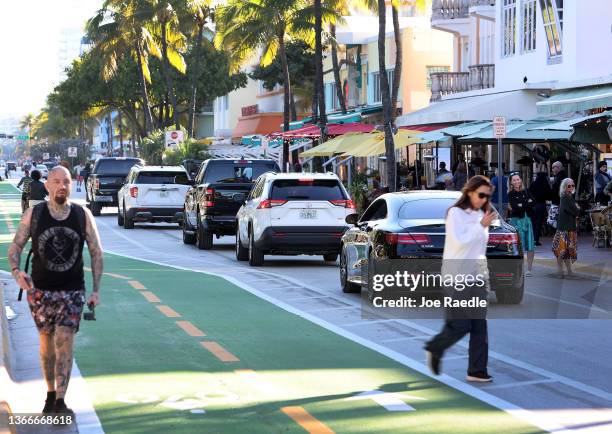 Cars drive along Ocean Drive after the city reopened it to one lane of traffic flowing southbound on January 24, 2022 in Miami Beach, Florida. The...