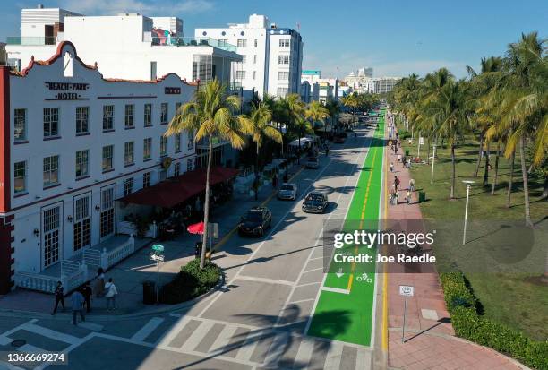 In an aerial view, cars drive along Ocean Drive after the city reopened it to one lane of traffic flowing southbound on January 24, 2022 in Miami...