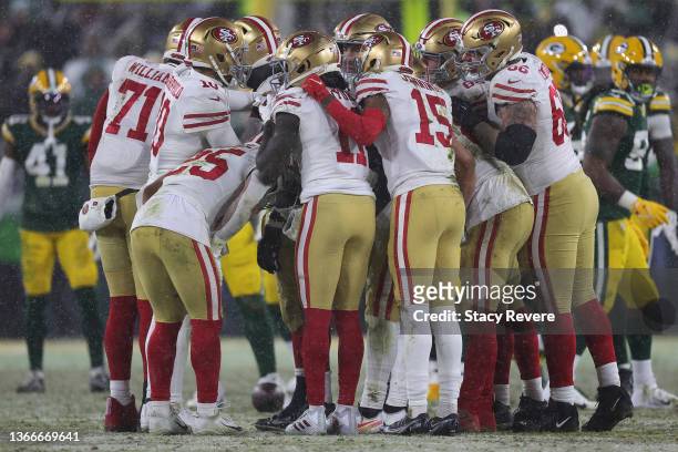 San Francisco 49ers offensive players huddle on the field during the game against the Green Bay Packers in NFC Divisional Playoff game at Lambeau...