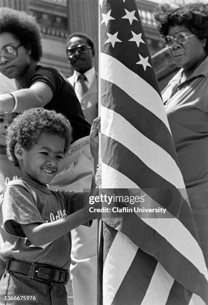 Child with an American flag during a rally.