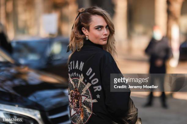 Cara Delevingne is seen wearing a black Dior jacket outside Dior during Paris Fashion Week Haute Couture Spring/Summer 2022 on January 24, 2022 in...