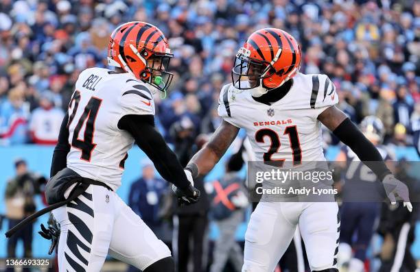 Vonn Bell of the Cincinnati Bengals celebrates a first quarter sack against the Tennessee Titans with teammate Mike Hilton in the AFC Divisional...