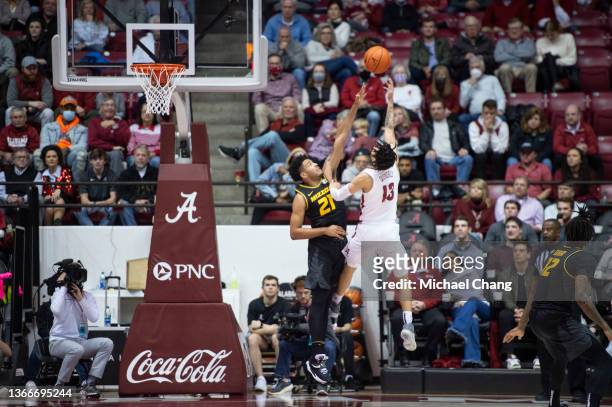 Jahvon Quinerly of the Alabama Crimson Tide takes a shot over Ronnie DeGray III of the Missouri Tigers during the second half of play at Coleman...
