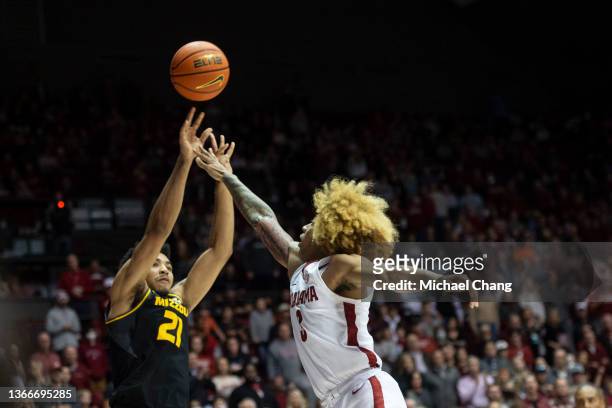Ronnie DeGray III of the Missouri Tigers takes a shot over JD Davison of the Alabama Crimson Tide during the second half of play at Coleman Coliseum...