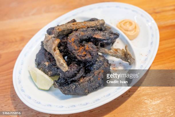 deep fried seafood with dark, ink outside - dark fruit ink stock pictures, royalty-free photos & images