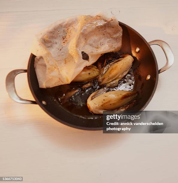 braised witloof chicory - witloof chicory stock pictures, royalty-free photos & images