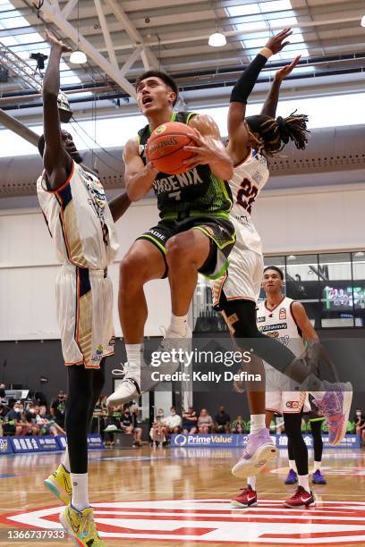 Reuben Te Rangi of the Phoenix drives to the basket against Majok Deng of the Taipans and Tahjere Mccall of the Taipans during the round eight NBL...