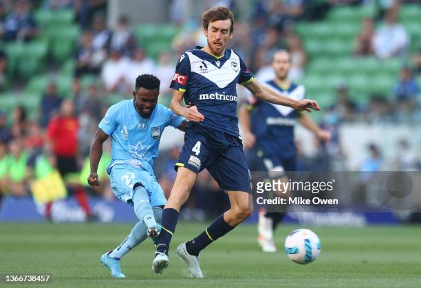 Elvis Kamsoba of Sydney FC shoots for goal while under pressure from Rai Marchan of the Victory during the round 11 A-League match between Melbourne...