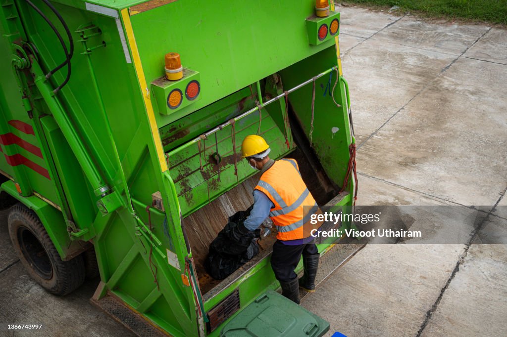 Garbage man collector,Garbage removal,Loading garbage in the garbage truck.