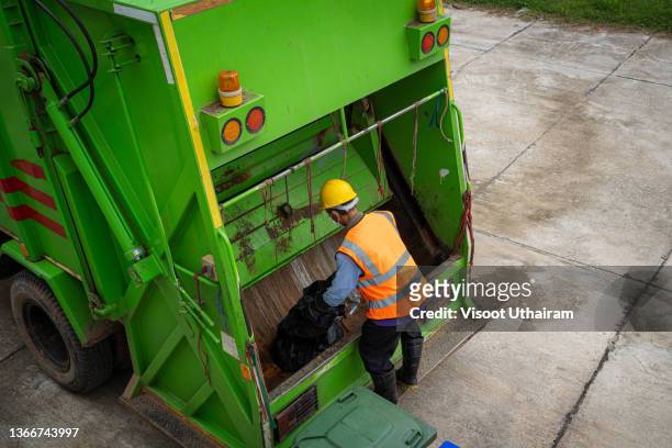 garbage man collector,garbage removal,loading garbage in the garbage truck. - dustbin lorry stock pictures, royalty-free photos & images