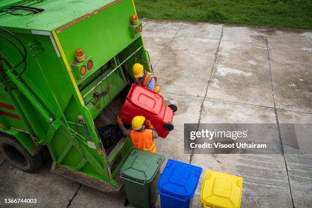 worker of recycling garbage are loading garbage in the garbage truck. - dustbin lorry stock pictures, royalty-free photos & images