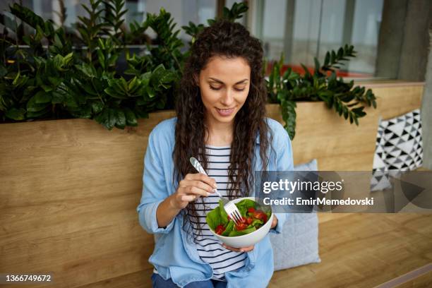 happy young business woman enjoying a healthy salad at work - lunch break stock pictures, royalty-free photos & images