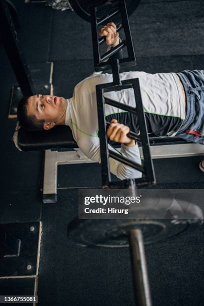 man doing bench press exercise - barbell overhead press stock pictures, royalty-free photos & images